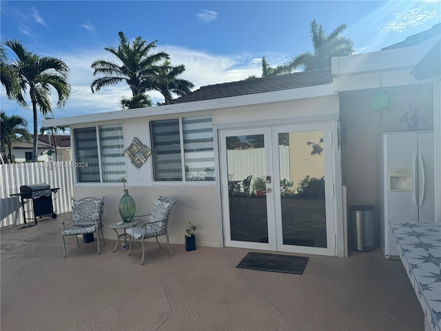 entrance to property with a patio and french doors