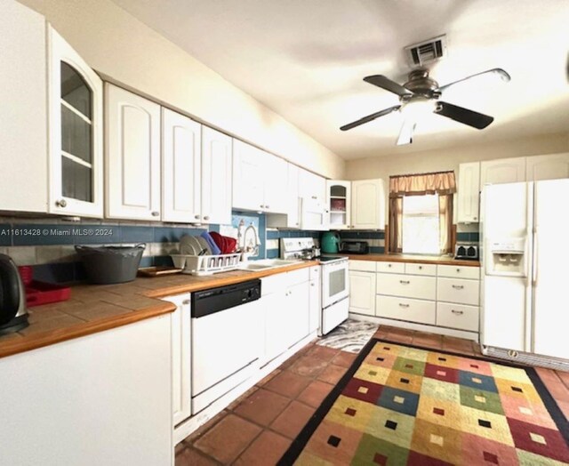 kitchen featuring white cabinetry, white appliances, backsplash, sink, and ceiling fan