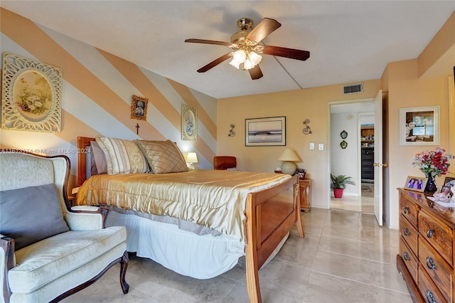 bedroom featuring light tile patterned floors, visible vents, and a ceiling fan