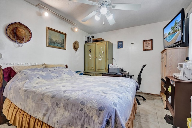 bedroom with light tile patterned flooring, track lighting, and ceiling fan