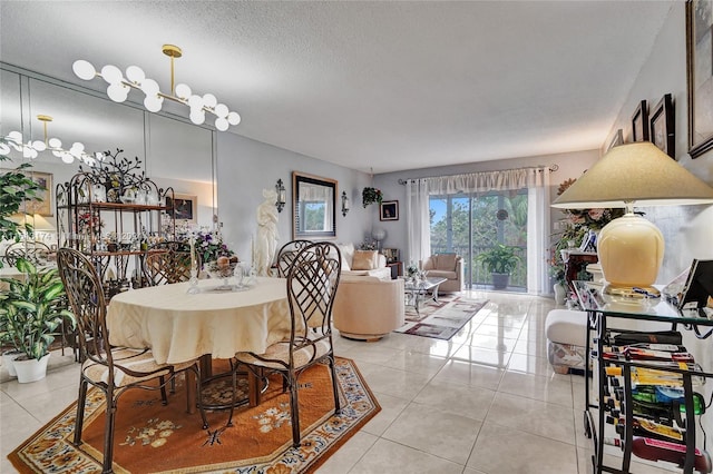 dining room with light tile patterned floors, a textured ceiling, and an inviting chandelier