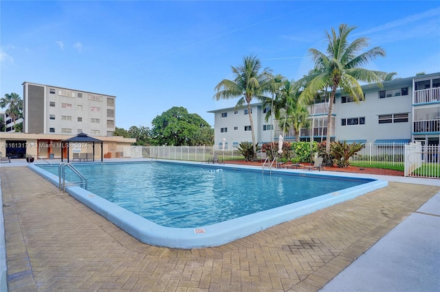 pool with a gazebo and fence