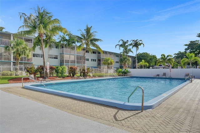 community pool featuring a patio area and fence