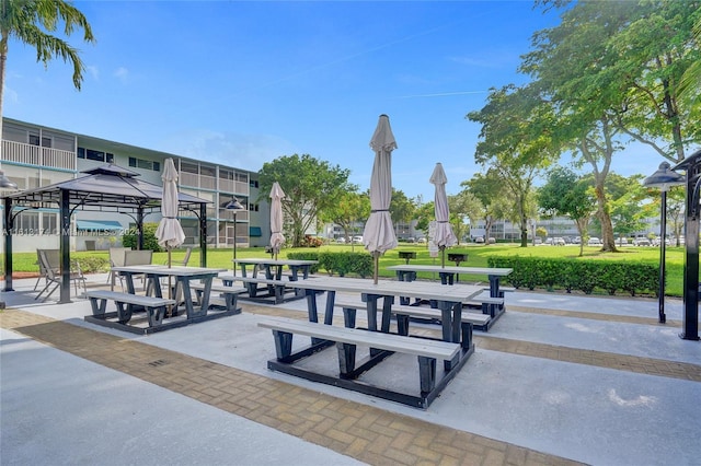 view of property's community with a gazebo and a yard