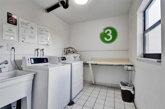 shared laundry area with a sink, light tile patterned floors, and washing machine and clothes dryer