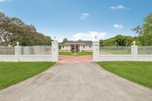 view of gate with a lawn