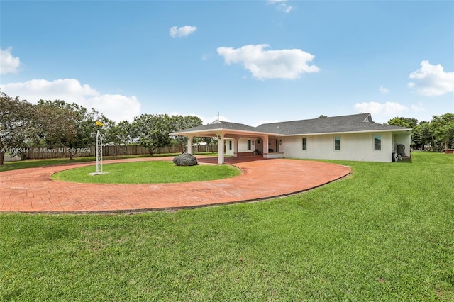 rear view of property with a yard