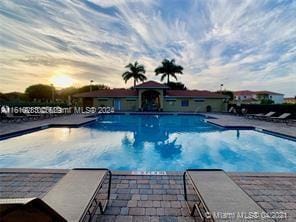 view of pool at dusk