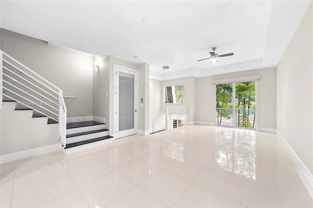 interior space featuring a tray ceiling and ceiling fan