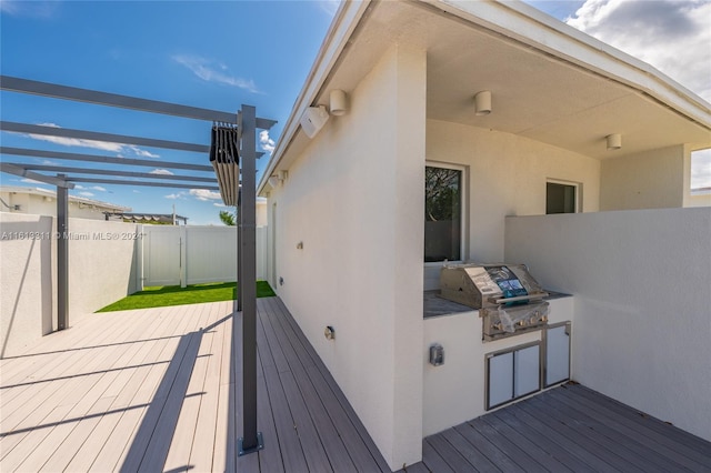 deck with a pergola and area for grilling