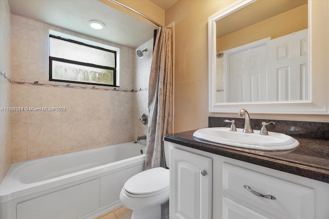 full bathroom featuring tile floors, shower / tub combo with curtain, toilet, and vanity