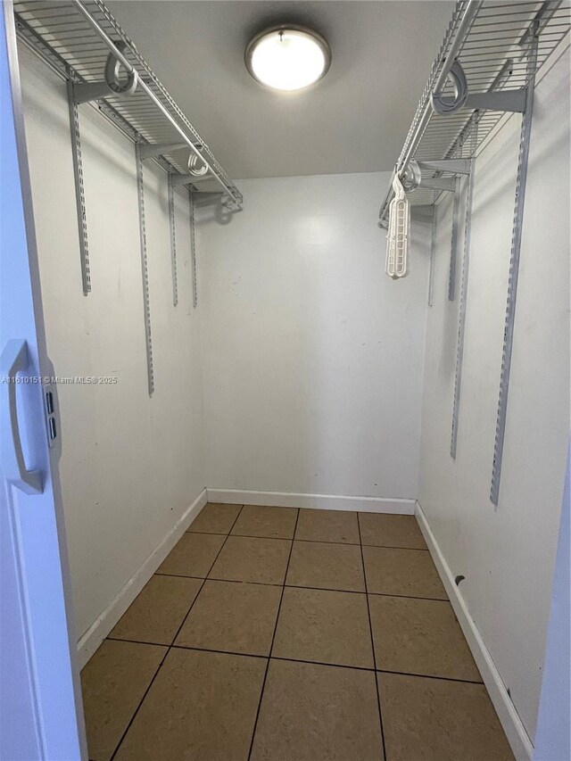 spacious closet featuring tile patterned flooring