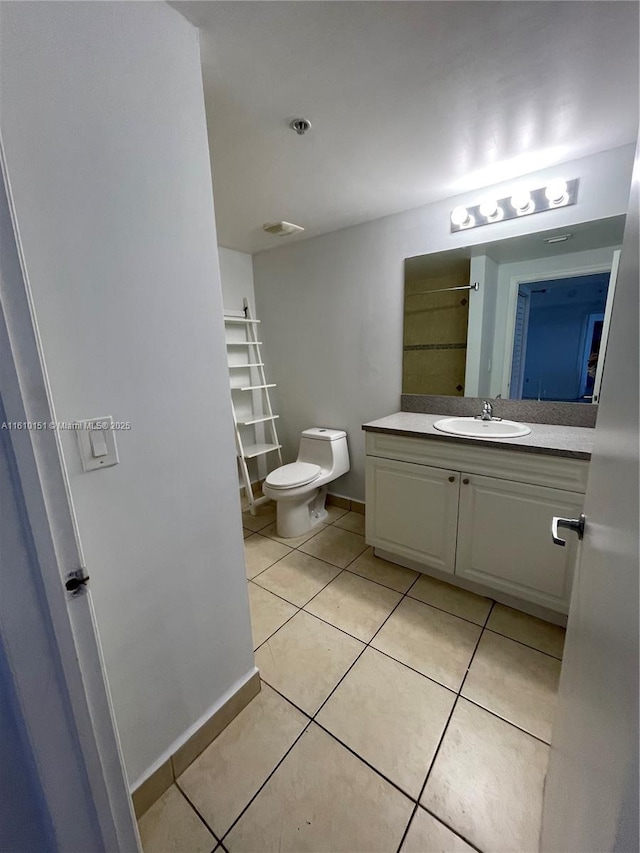 bathroom featuring tile patterned floors, toilet, and vanity