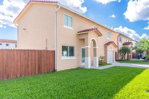 mediterranean / spanish-style home with a front lawn