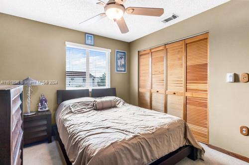 bedroom featuring a closet, carpet floors, and ceiling fan