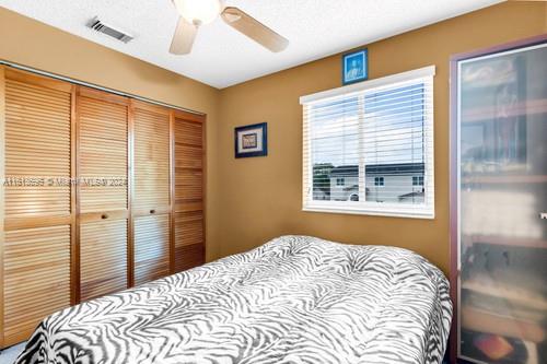 bedroom featuring ceiling fan and a closet