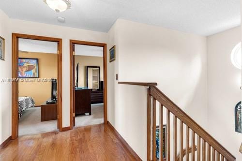 hallway with hardwood / wood-style flooring