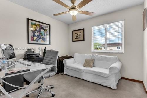 carpeted home office with ceiling fan