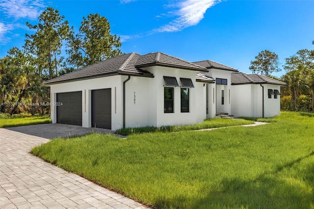 view of side of home with a yard and a garage