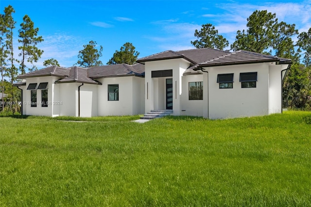 back of house featuring a lawn