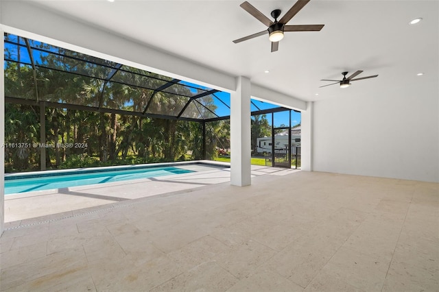 view of pool with a patio, ceiling fan, and a lanai