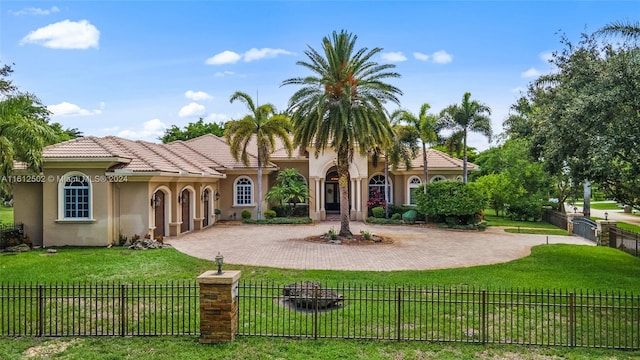 mediterranean / spanish-style home with a front yard