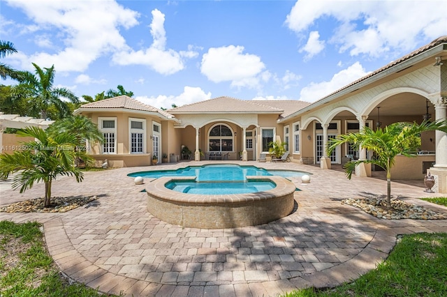 view of swimming pool with an in ground hot tub and a patio area