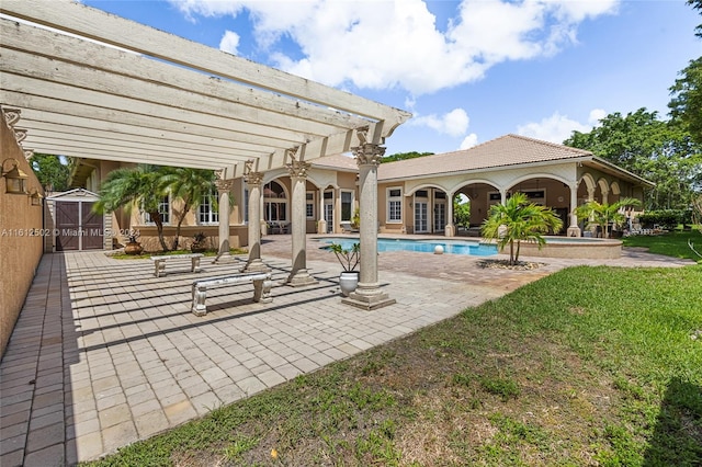 view of swimming pool with a pergola, a patio, and an outdoor structure