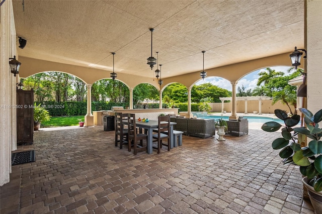 view of patio featuring outdoor lounge area, ceiling fan, and a fenced in pool