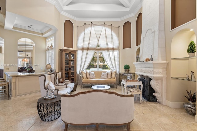 living room featuring a high ceiling, a fireplace, light tile flooring, and crown molding