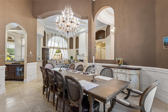 dining area featuring crown molding, a wealth of natural light, and light tile floors