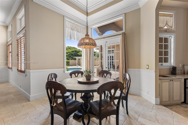 tiled dining room featuring french doors and crown molding