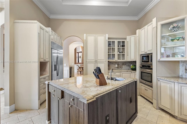 kitchen with stainless steel appliances, tasteful backsplash, ornamental molding, sink, and light tile floors