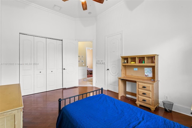 bedroom featuring dark hardwood / wood-style floors, ceiling fan, a closet, and a towering ceiling