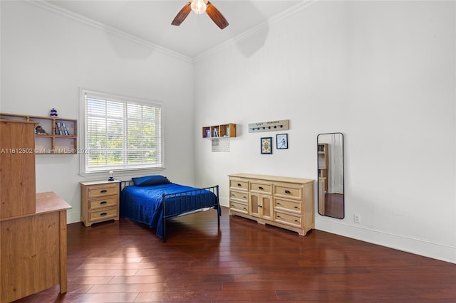 bedroom with a high ceiling, ceiling fan, dark hardwood / wood-style flooring, and ornamental molding