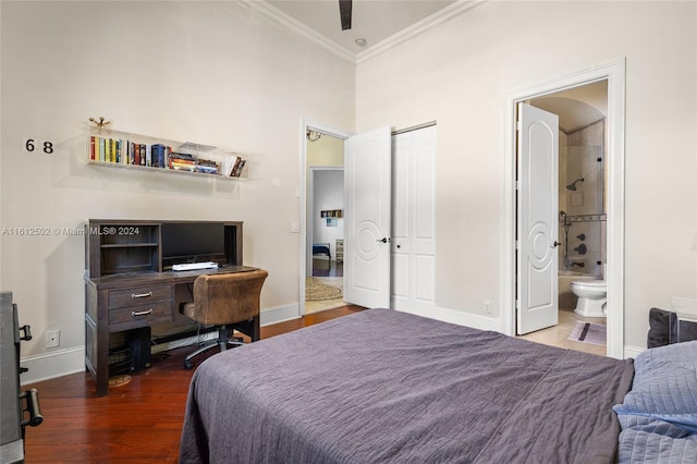 bedroom featuring ceiling fan, a closet, crown molding, connected bathroom, and hardwood / wood-style flooring