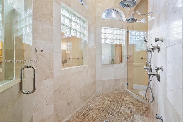 bathroom featuring a shower with door