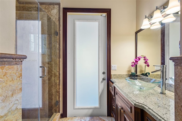 bathroom with a shower with door and oversized vanity