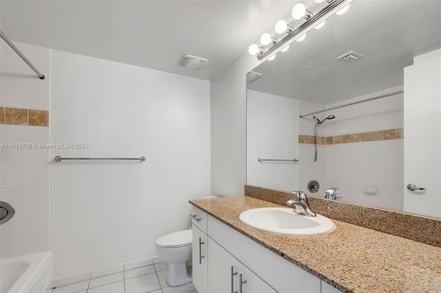 full bathroom featuring tile patterned flooring, vanity, toilet, and tiled shower / bath combo