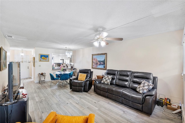11091 NW 7th St Unit 202, Miami, FL 33172 - living area featuring visible vents, ceiling fan with notable chandelier, light wood finished floors, and a textured ceiling