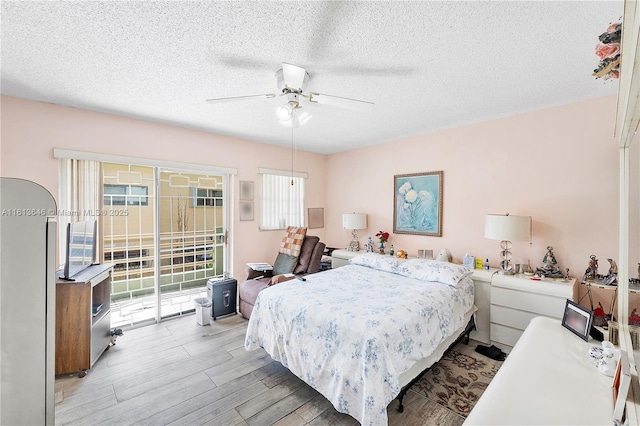 11091 NW 7th St Unit 202, Miami, FL 33172 - bedroom with access to outside, light wood-style floors, ceiling fan, and a textured ceiling