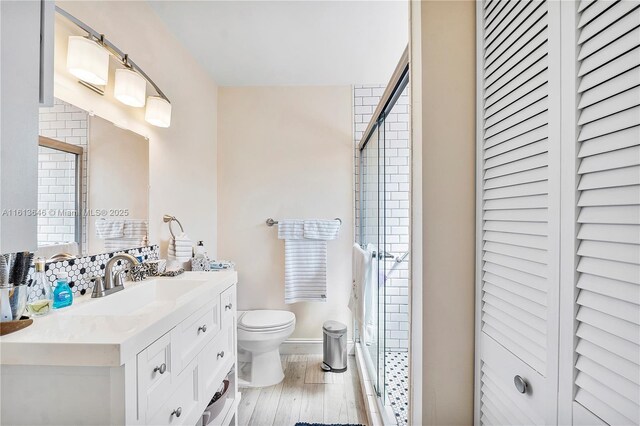 11091 NW 7th St Unit 202, Miami, FL 33172 - bathroom with a closet, toilet, vanity, wood finished floors, and a stall shower