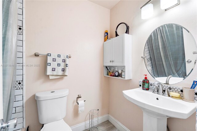 11091 NW 7th St Unit 202, Miami, FL 33172 - bathroom featuring baseboards, a sink, and toilet