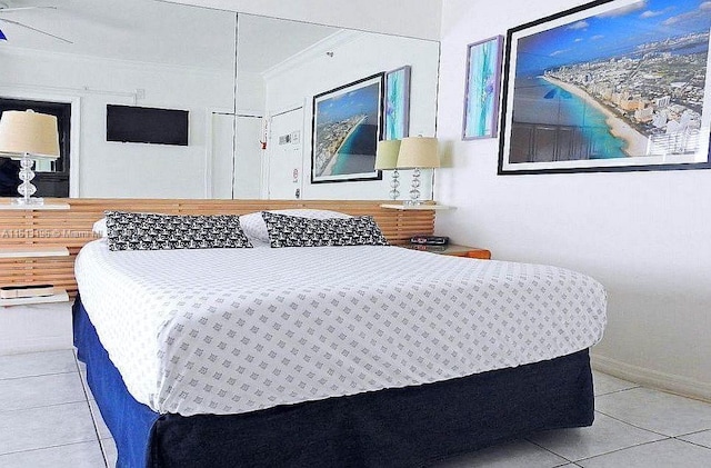 tiled bedroom featuring ornamental molding