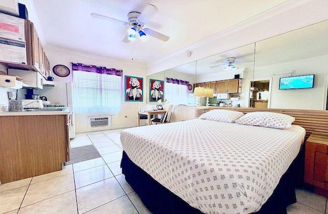 bedroom with crown molding, light tile patterned flooring, and a wall unit AC