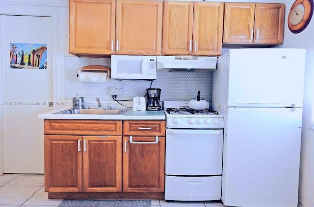 kitchen with tasteful backsplash, white appliances, sink, and light tile patterned floors