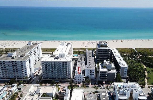 drone / aerial view featuring a water view and a beach view