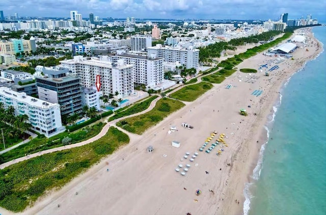 drone / aerial view featuring a view of the beach and a water view