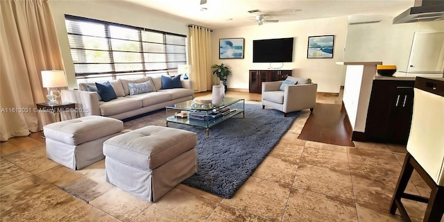 living area with visible vents, ceiling fan, and baseboards