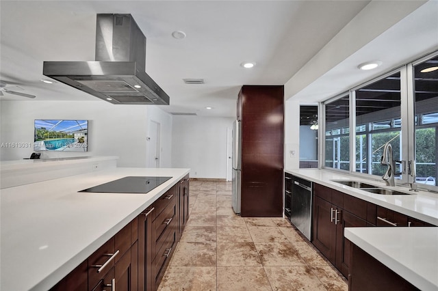 kitchen with light countertops, visible vents, a sink, island range hood, and black appliances